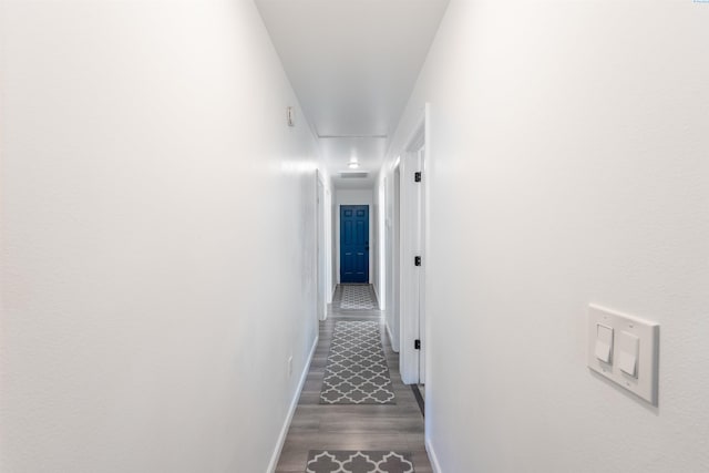 corridor with dark hardwood / wood-style floors