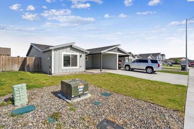407 Dawson Ln, Pasco, WA 99301 - view of front of home featuring board and batten siding, a carport, and concrete driveway