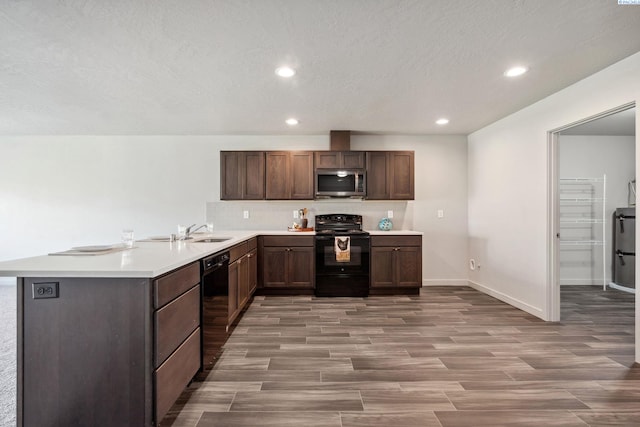 407 Dawson Ln, Pasco, WA 99301 - kitchen with black appliances, light countertops, tasteful backsplash, wood finished floors, and a peninsula