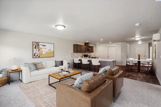 407 Dawson Ln, Pasco, WA 99301 - living area with an AC wall unit, baseboards, recessed lighting, and carpet