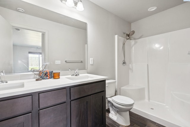 407 Dawson Ln, Pasco, WA 99301 - bathroom featuring toilet, wood finished floors, a shower, and double vanity