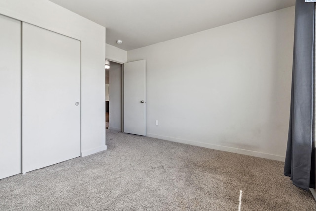 407 Dawson Ln, Pasco, WA 99301 - unfurnished bedroom with carpet flooring, a closet, and baseboards