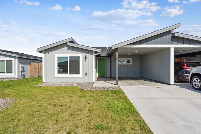 407 Dawson Ln, Pasco, WA 99301 - view of front facade featuring board and batten siding, a carport, and concrete driveway