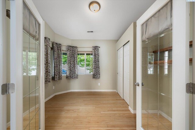 2704 Iris St, West Richland, WA 99353 - unfurnished bedroom featuring light wood-style floors, baseboards, and two closets