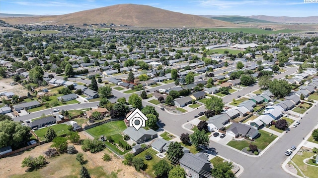 2704 Iris St, West Richland, WA 99353 - aerial overview of property's location featuring a mountainous background