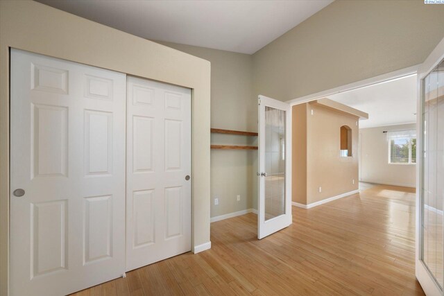 2704 Iris St, West Richland, WA 99353 - unfurnished bedroom with light wood-type flooring, french doors, baseboards, and a closet