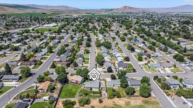 2704 Iris St, West Richland, WA 99353 - aerial overview of property's location with a mountain backdrop