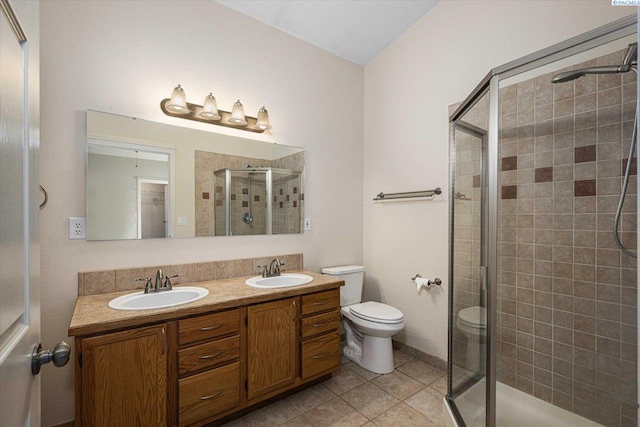 2704 Iris St, West Richland, WA 99353 - bathroom featuring a shower stall, toilet, tile patterned floors, and double vanity