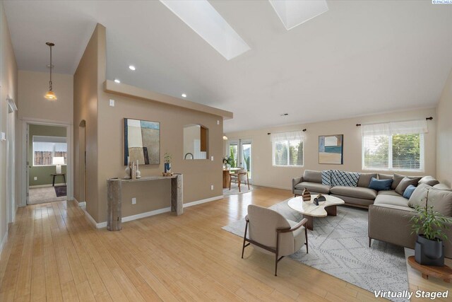 2704 Iris St, West Richland, WA 99353 - living room with light wood-style flooring, baseboards, a skylight, and recessed lighting