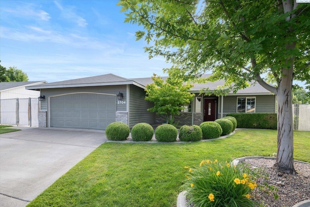 2704 Iris St, West Richland, WA 99353 - ranch-style home with an attached garage, driveway, and brick siding
