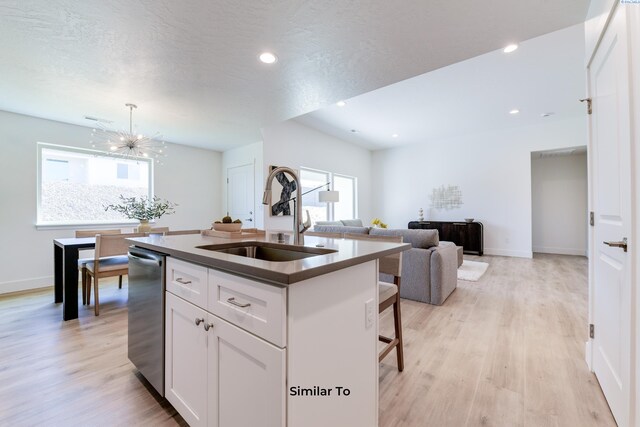 2945 S Penn St, Kennewick, WA 99338 - kitchen featuring a sink, stainless steel dishwasher, a chandelier, an island with sink, and white cabinetry