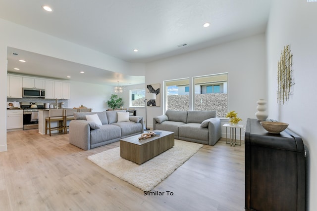 2945 S Penn St, Kennewick, WA 99338 - living room with recessed lighting, a chandelier, light wood-style flooring, and baseboards