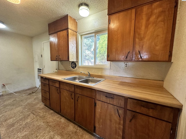 kitchen featuring sink and a textured ceiling