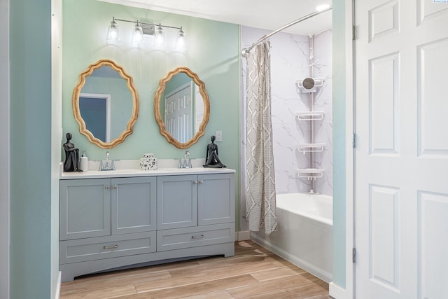 bathroom with shower / bathtub combination with curtain, vanity, and hardwood / wood-style flooring