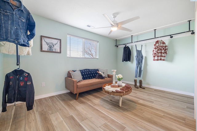 living room with ceiling fan and light hardwood / wood-style floors