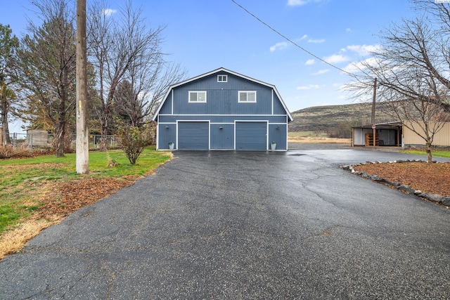 view of side of home with a garage and a carport