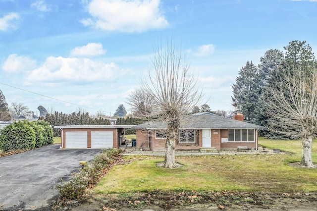 single story home featuring a garage and a front yard