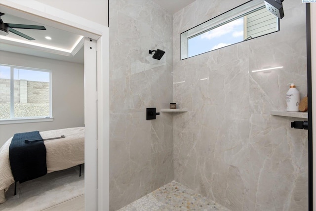 bathroom featuring ceiling fan and tiled shower