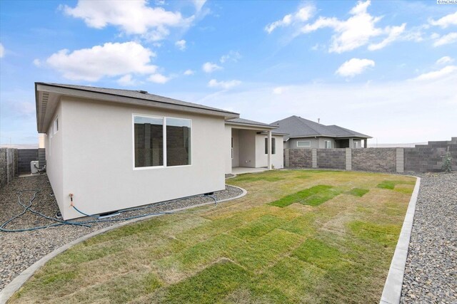 rear view of property with a yard