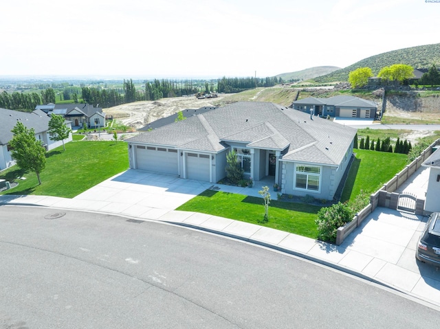 5593 S Lyle Pl, Kennewick, WA 99337 - view of front facade featuring a garage, concrete driveway, a mountain view, and a residential view