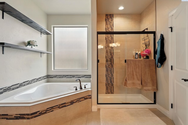 bathroom featuring a garden tub, a stall shower, tile patterned flooring, and recessed lighting