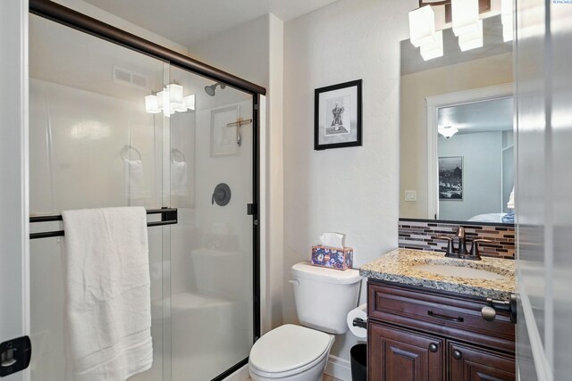 full bath with visible vents, a stall shower, backsplash, and vanity