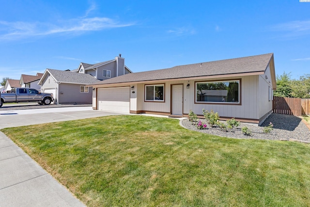 627 N Williams St, Kennewick, WA 99336 - view of front of house with an attached garage, concrete driveway, and a shingled roof