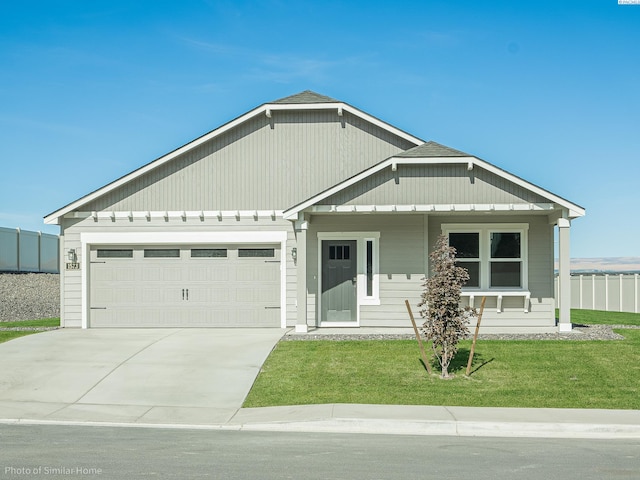 view of front of home with a garage and a front yard