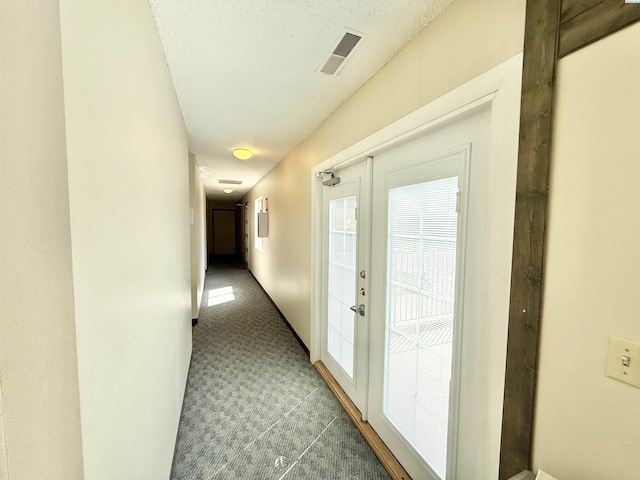 2912 W Hood Ave Unit D104, Kennewick, WA 99336 - hallway featuring carpet, a textured ceiling, and french doors