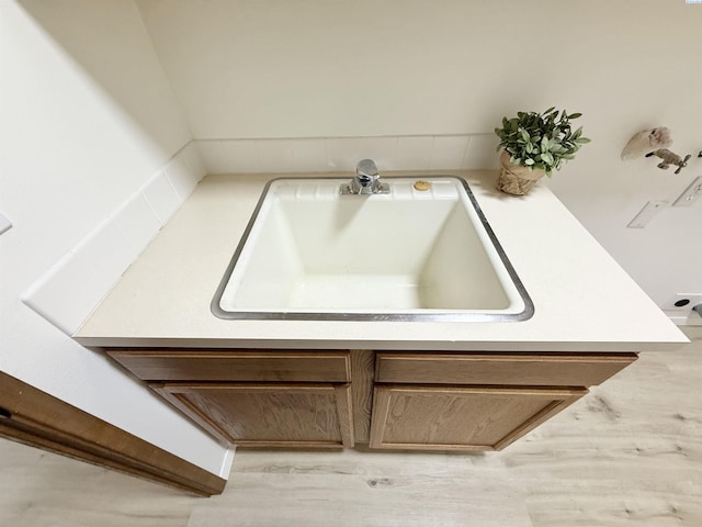 detailed view of a sink and wood finished floors