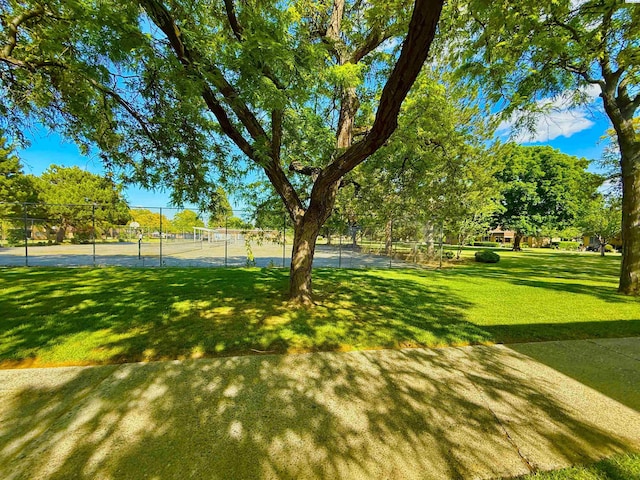 view of yard with a tennis court