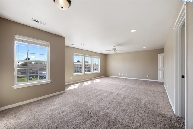 spare room with recessed lighting, carpet flooring, baseboards, visible vents, and a ceiling fan