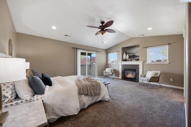 bedroom featuring vaulted ceiling, access to exterior, carpet flooring, a glass covered fireplace, and visible vents