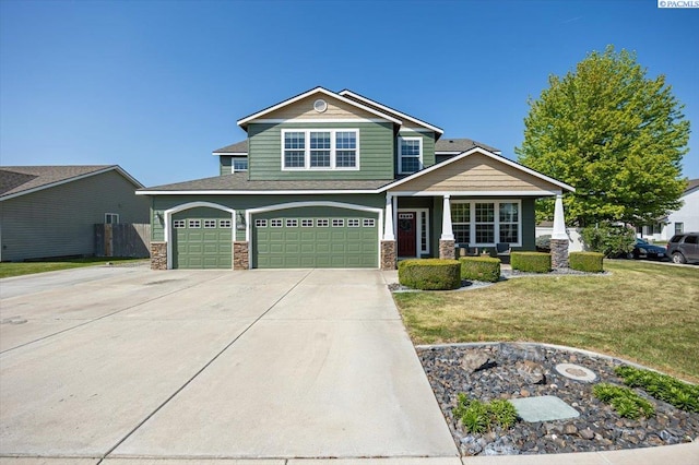 craftsman inspired home with concrete driveway, stone siding, a porch, a front lawn, and a garage