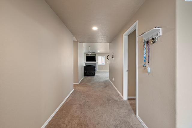 hall with carpet flooring and baseboards