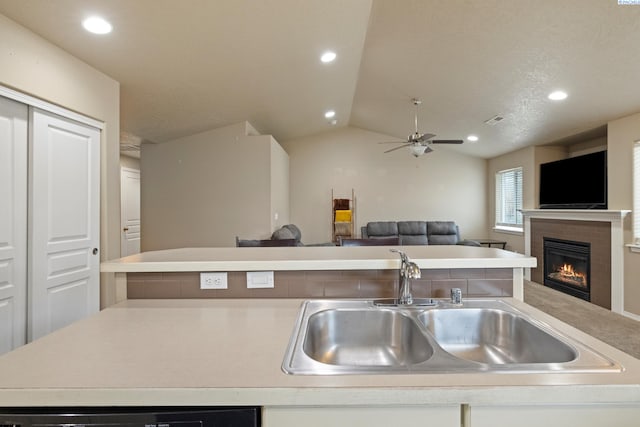 kitchen with ceiling fan, lofted ceiling, and sink