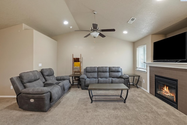 living room with light carpet, a brick fireplace, vaulted ceiling, and ceiling fan