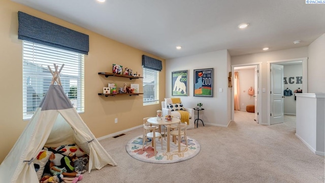 game room with light colored carpet