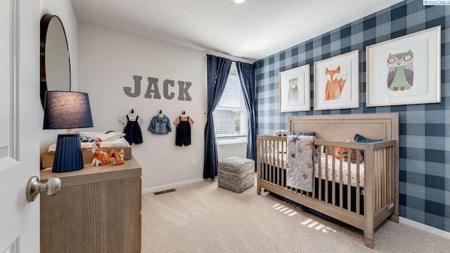 carpeted bedroom featuring a textured ceiling