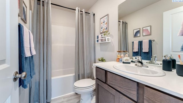 full bathroom featuring vanity, toilet, shower / tub combo, and hardwood / wood-style floors