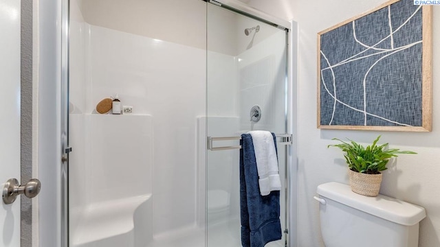 bathroom featuring an enclosed shower and toilet