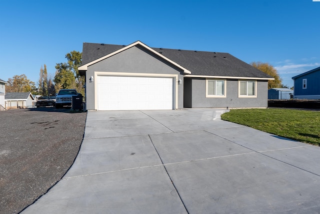 ranch-style house featuring a garage and a front lawn