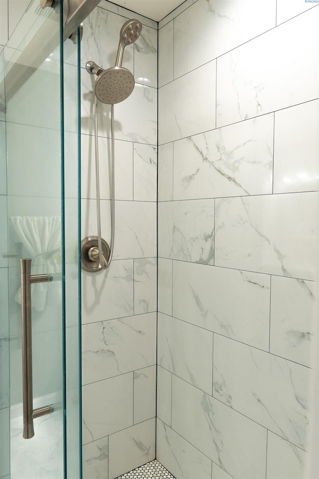 bathroom with tiled shower