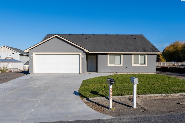 ranch-style house featuring a garage and a front yard