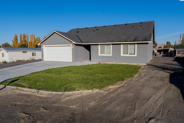 ranch-style home featuring a garage and a front yard