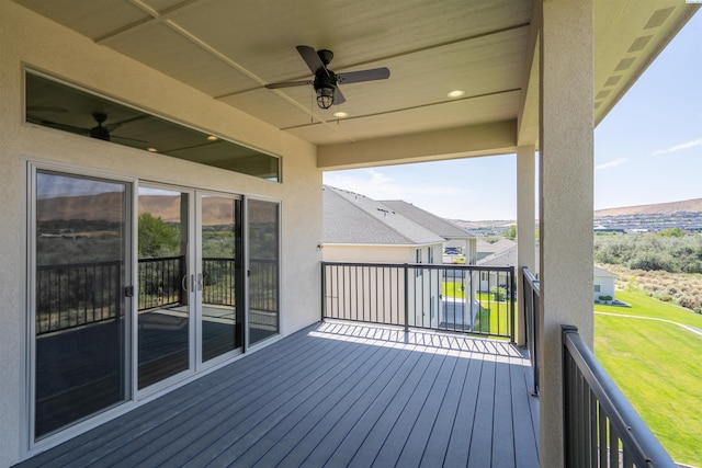 wooden terrace featuring a ceiling fan