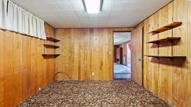 spare room featuring wooden walls