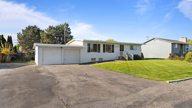 single story home featuring an attached garage, driveway, and a front lawn