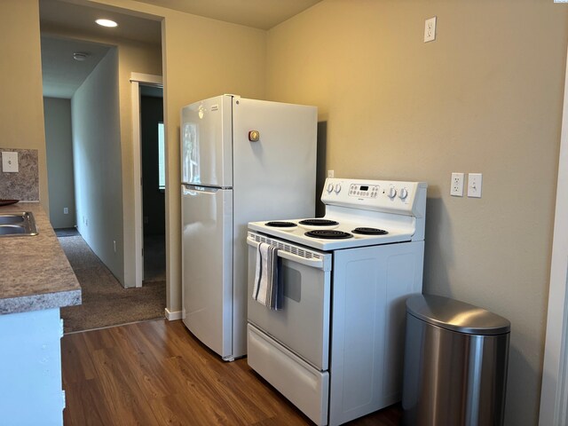 1320 NE Harvey Rd, Pullman, WA 99163 - kitchen with white appliances, dark wood-style flooring, a sink, and light countertops