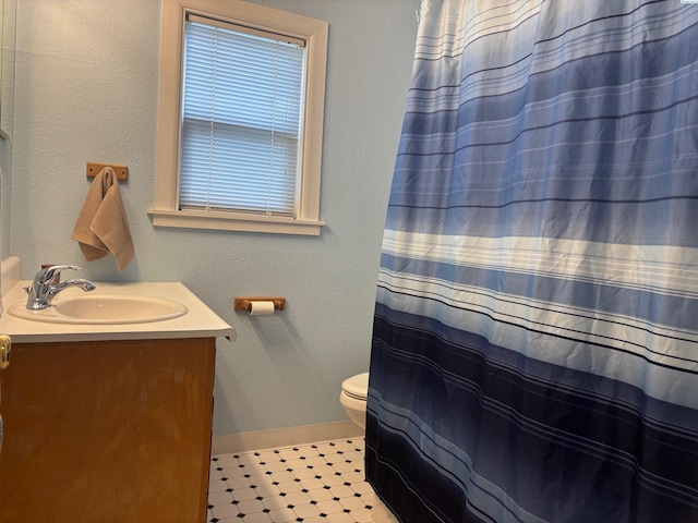 1320 NE Harvey Rd, Pullman, WA 99163 - bathroom featuring vanity, baseboards, toilet, and a shower with curtain